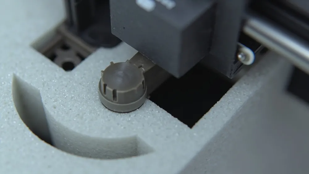 Printer nozzle assembly in a shaped foam cavity