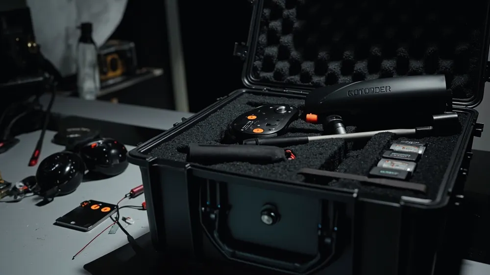 Custom foam holding a sprayer control module and battery packs in a case