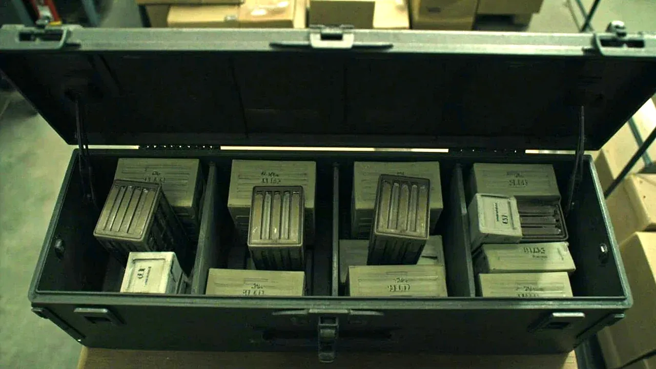 The box open on a bench, ammunition cartons standing upright in compartments