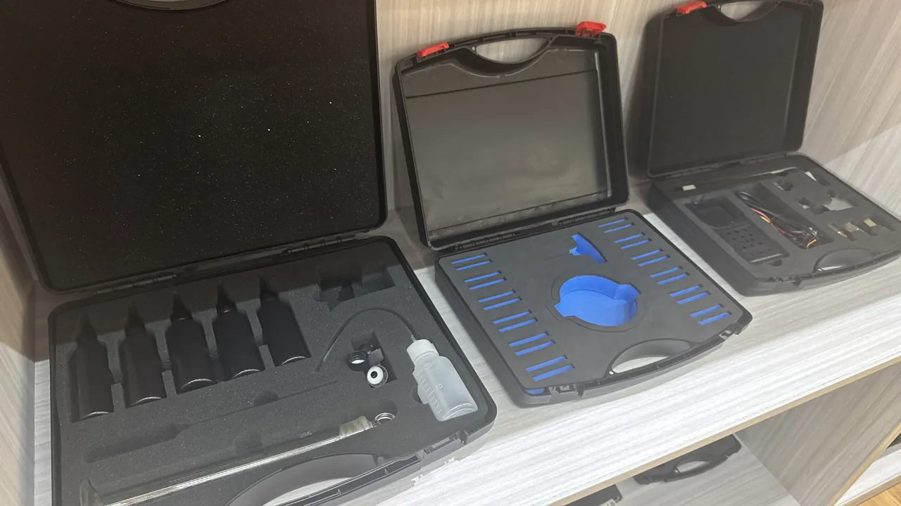 Surveying and cleaning tools stored in tiers inside a field archaeology case