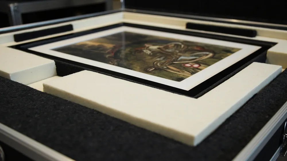 Soft padded compartments cradling a framed picture in a case