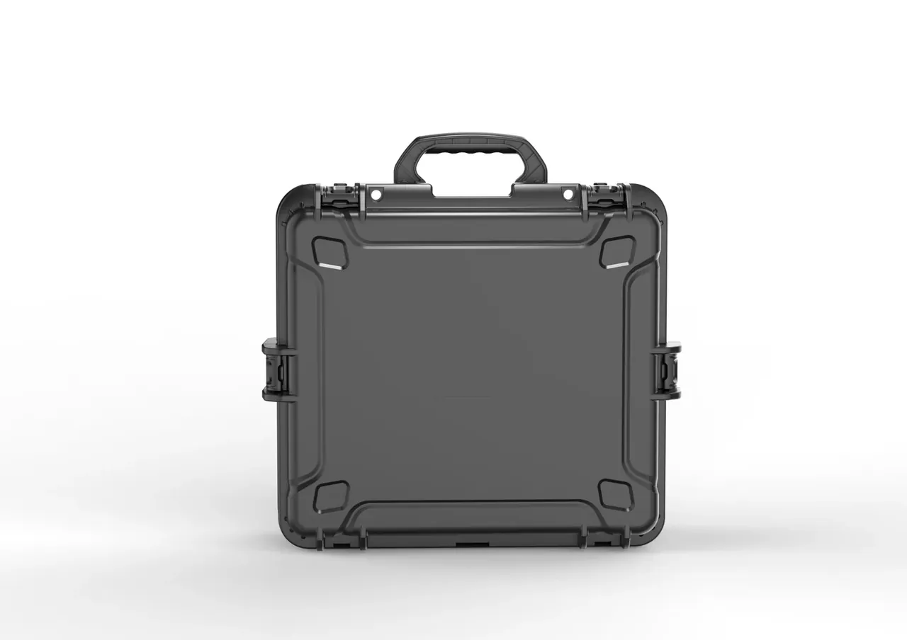Black case closed, front view, textured folding handle, two hinges with round pins on the upper edge, a raised rectangular label panel in the middle