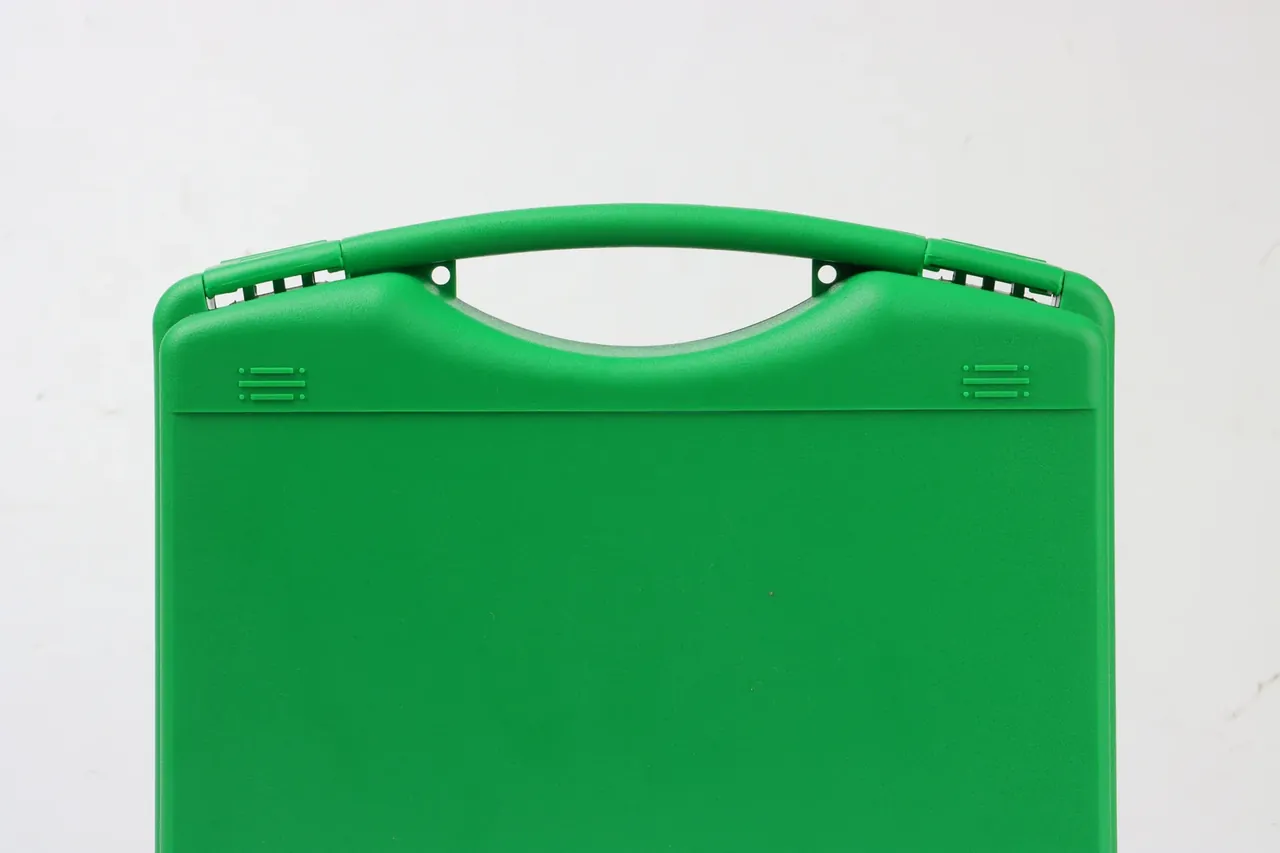 Case Export Packaging: upright green case with folding handle raised, moulded marks and hinge pins at the corners