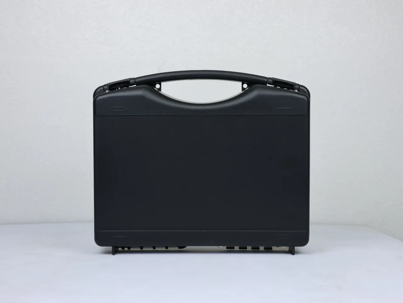 Case Injection Molding Machine output: two-tone case upright, black front, pale grey back shell, black hinge pin, vertical parting line