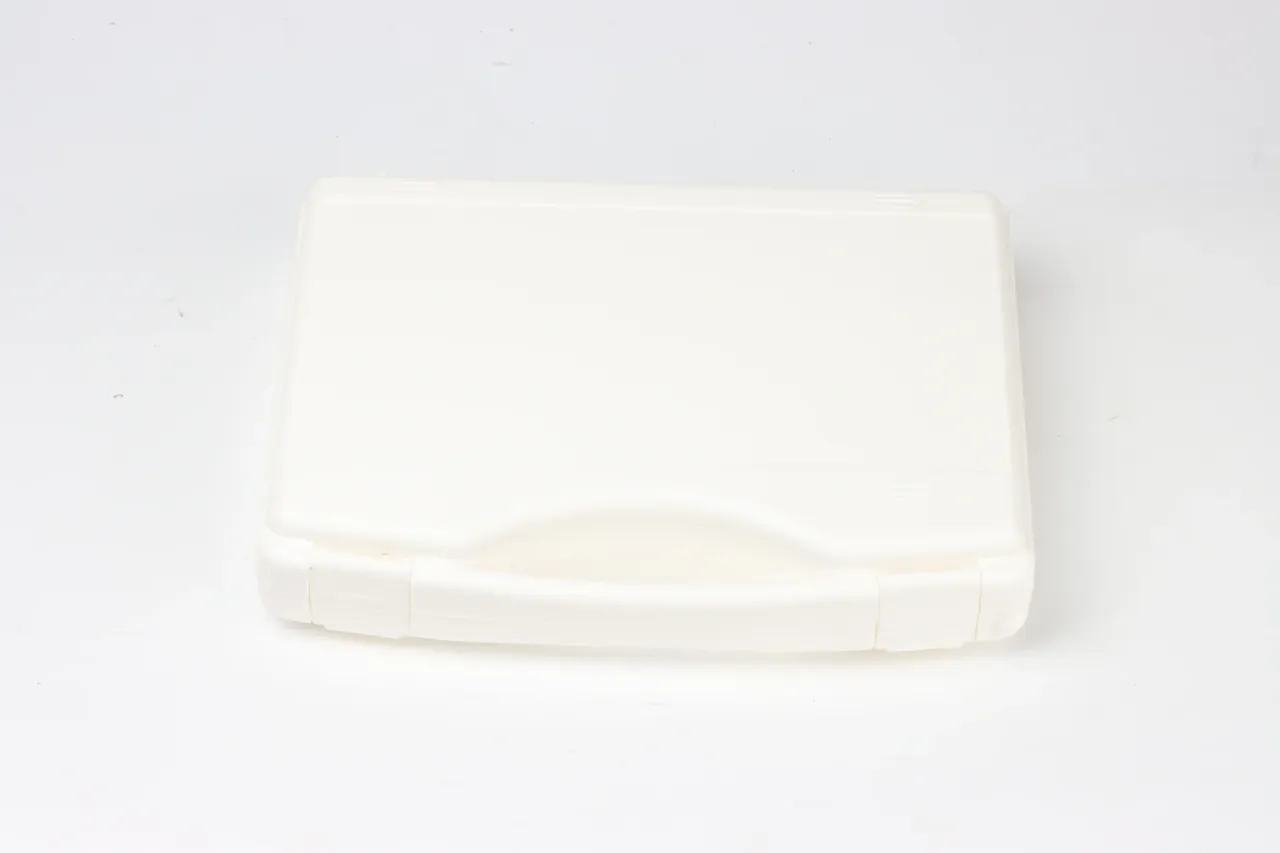 Mould Life trial case in off-white, lid closed with a wavy seam along the front edge, thin-walled lid border, rounded corners, pale grey background