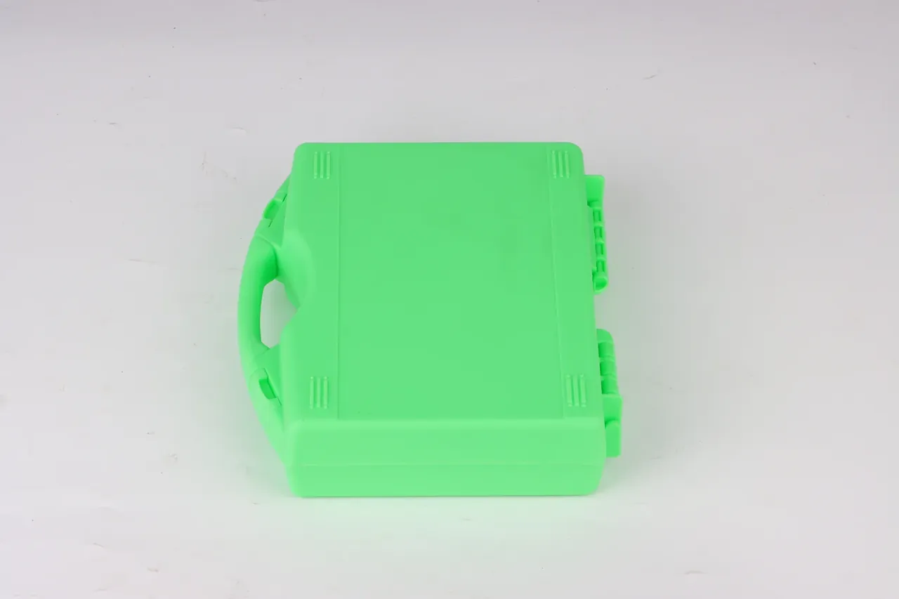 Case Showroom: green case on its side, handle left, two latches and hinge blocks along the right edge, rib lines at the corners