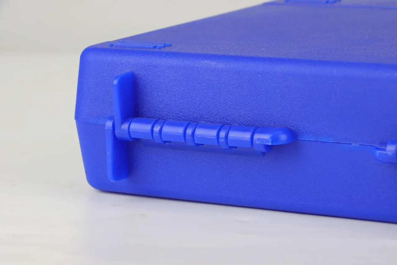 Case Showroom: side seam of a blue case with a long ribbed bar held by a clamp, rounded corner, fine pebble texture