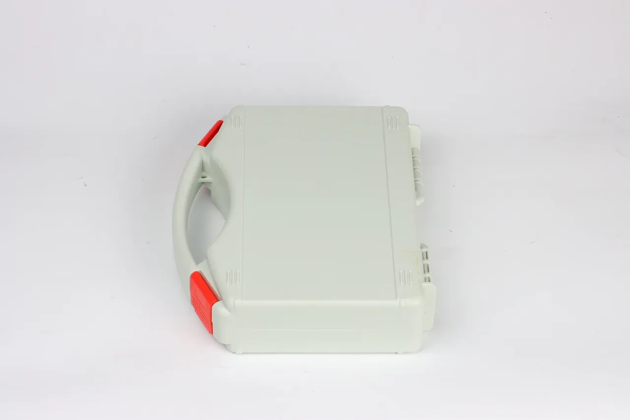 Colored Protective Case: pale grey box on its side, curved handle and two red latches at left, three latch grooves along the right edge
