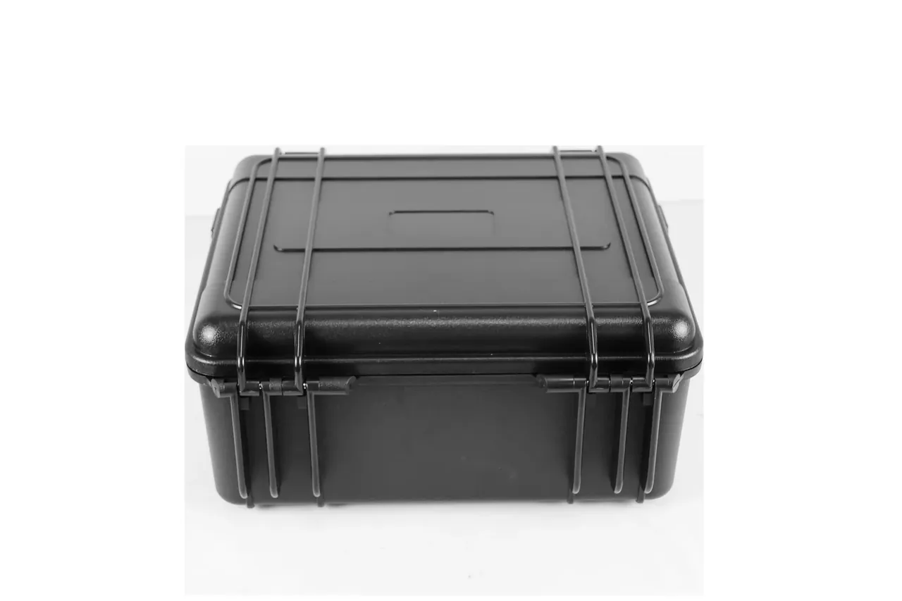 A raised three-quarter view, both latches and the round knob clear, the handle folded down, a recess centred on the lid