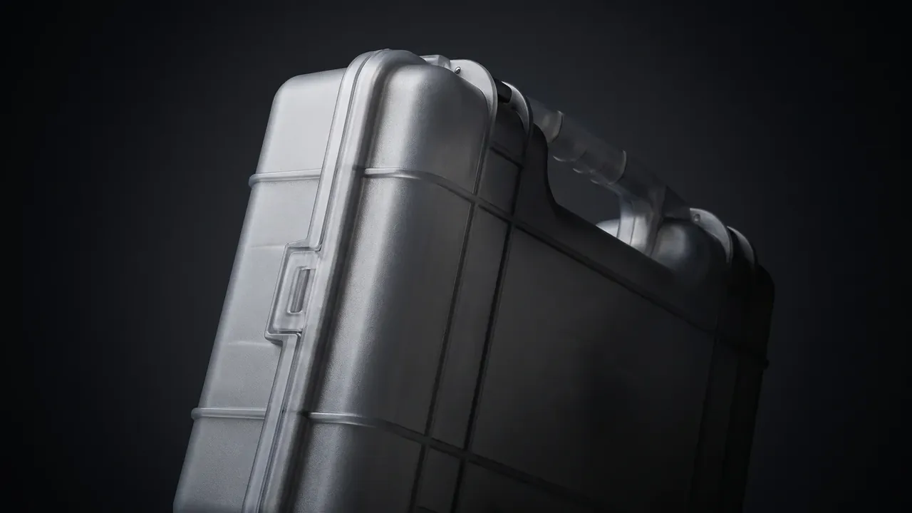 Deployable Hard Case: case standing on end on dark background, cross ribs on the lid, recessed side latch