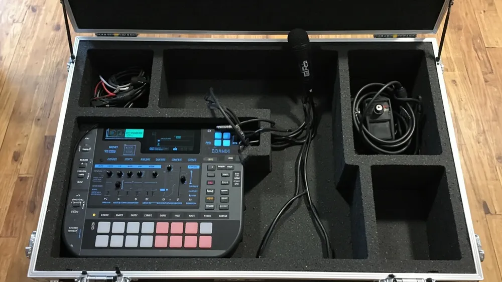 Foam compartments for an audio controller, wireless mic and cables in a case