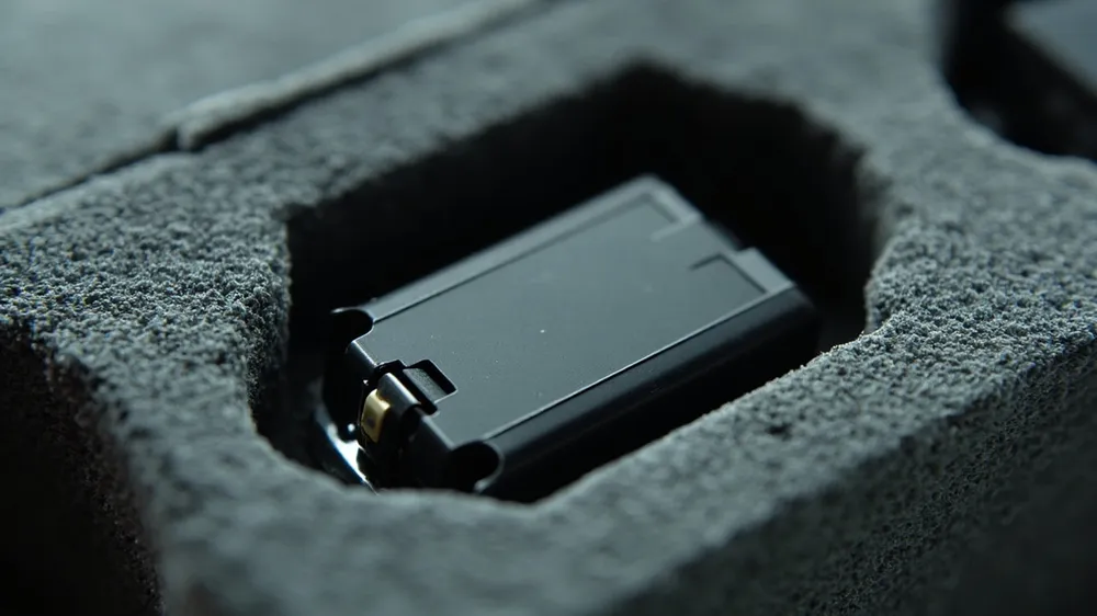 Close-up of a battery resting in a shaped foam cavity