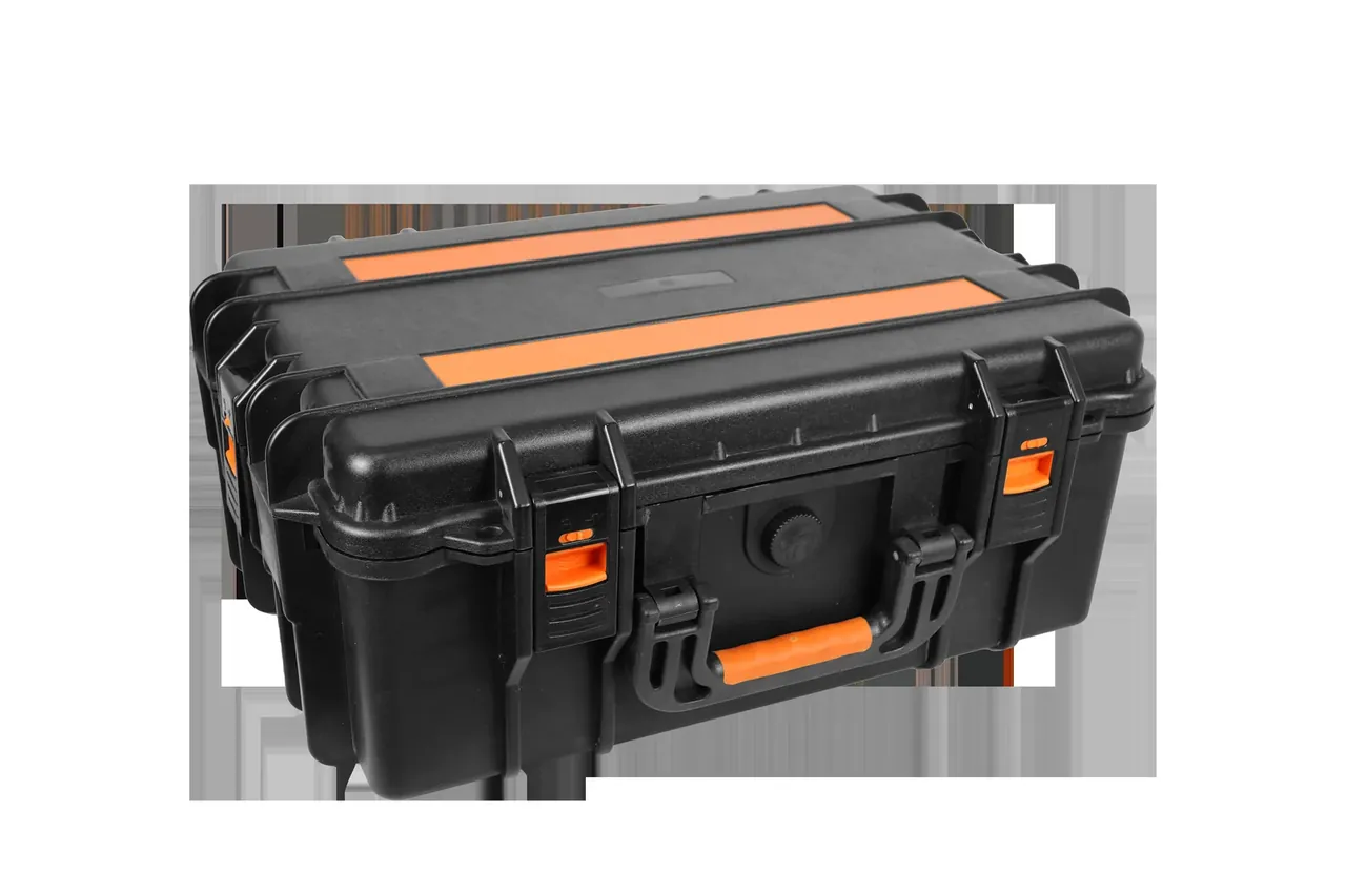 Close view from above at an angle, two orange bands with front latches and the orange handle in frame, a foot at lower right