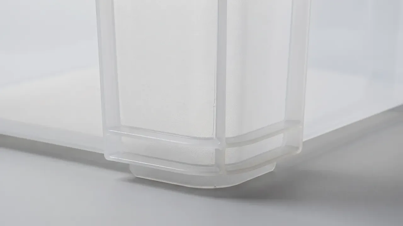 Frosted case corner close-up, vertical ribs meeting the base rim