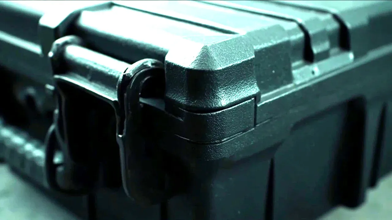 Close-up of a hand tool case hinge and latch corner with a rubber bumper