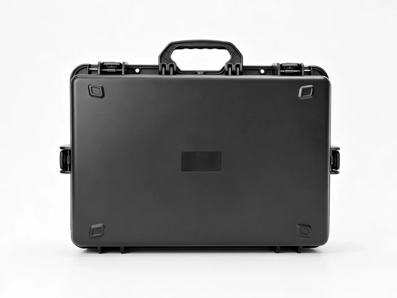 The same case closed and shot straight on, recessed corner pads, two latches along the lid edge, handle centred on top
