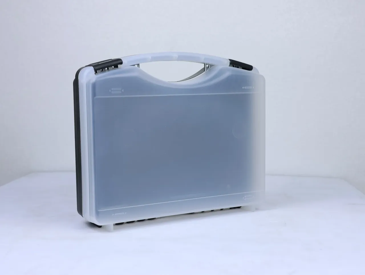 Knife Case: frosted translucent case at three-quarter angle, black spine edge on the left, two white feet, faint round mould mark