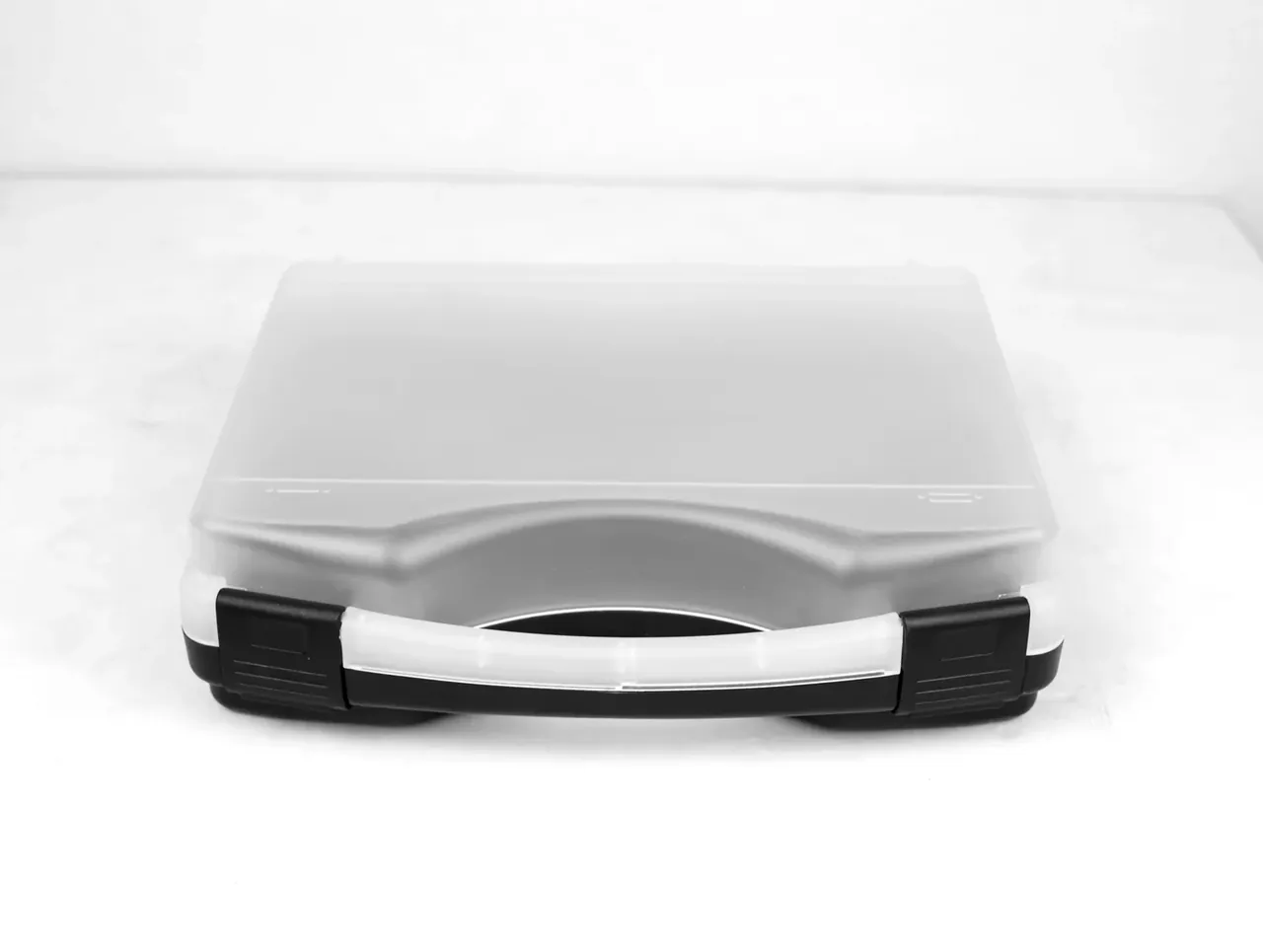 Knife Case: low view of a frosted case lying flat, white handle to the front, black overmoulded blocks at both ends, pale grey surface