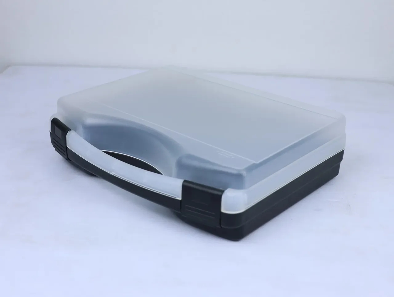 Knife Case: the box angled from the left rear, frosted lid over a black base, one black corner latch beside the white handle