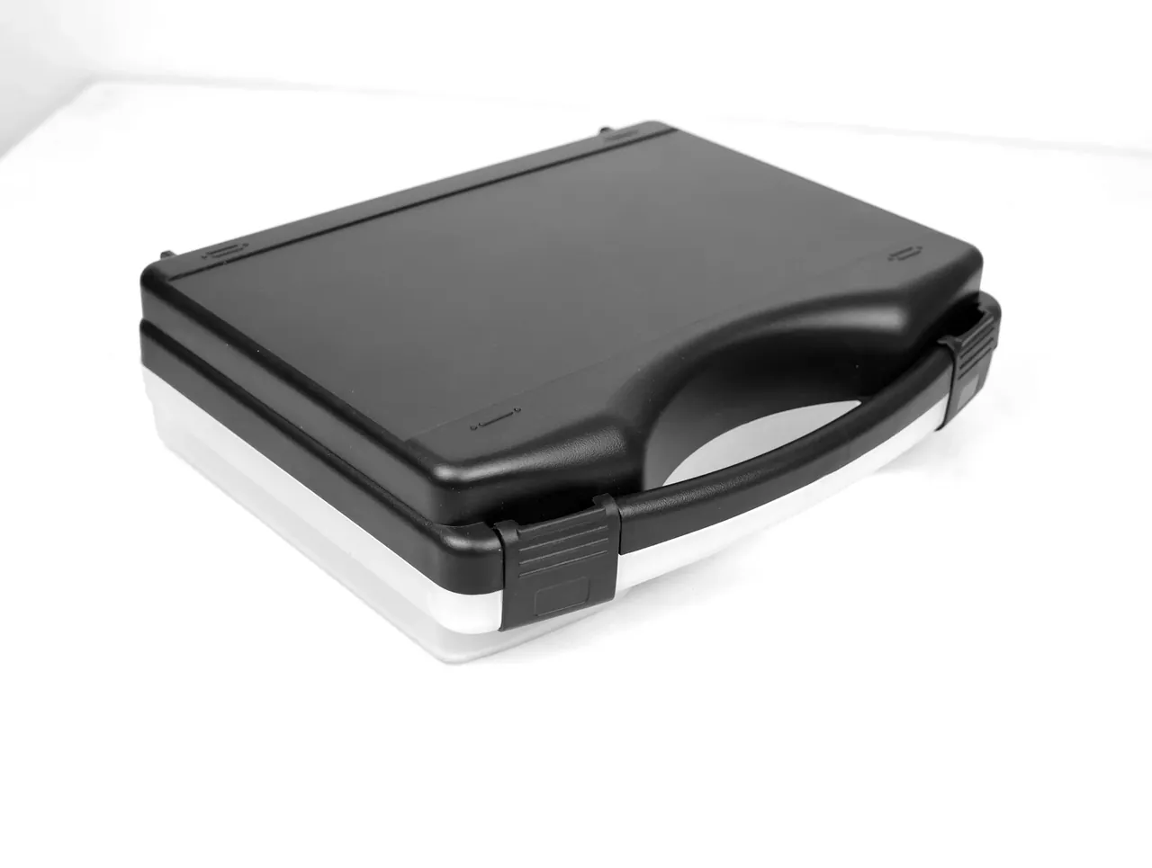 Knife Case: lying at an angle on a bluish white surface, dark seam between lid and base, one latch along the base edge