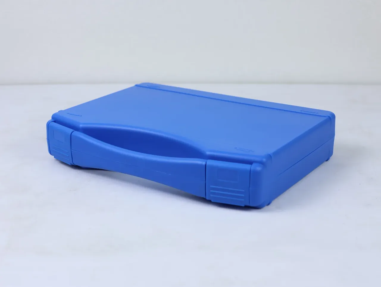 Large Protective Case: a blue case set diagonally on a white floor, one full-length latch closed and the lid seam flush