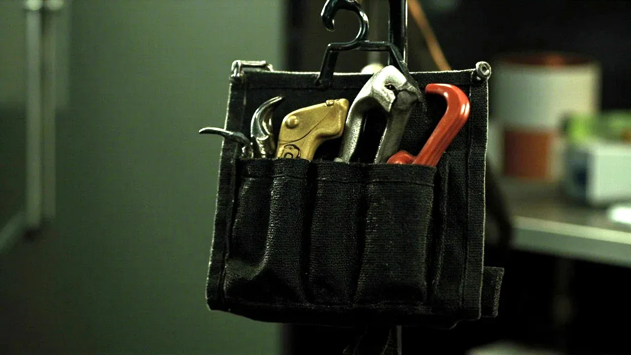 A tool pouch hung on a hook between tasks in a maintenance bay