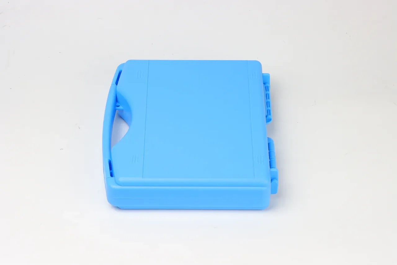 Light blue case from above, handle at the left, two latches standing proud of the right wall