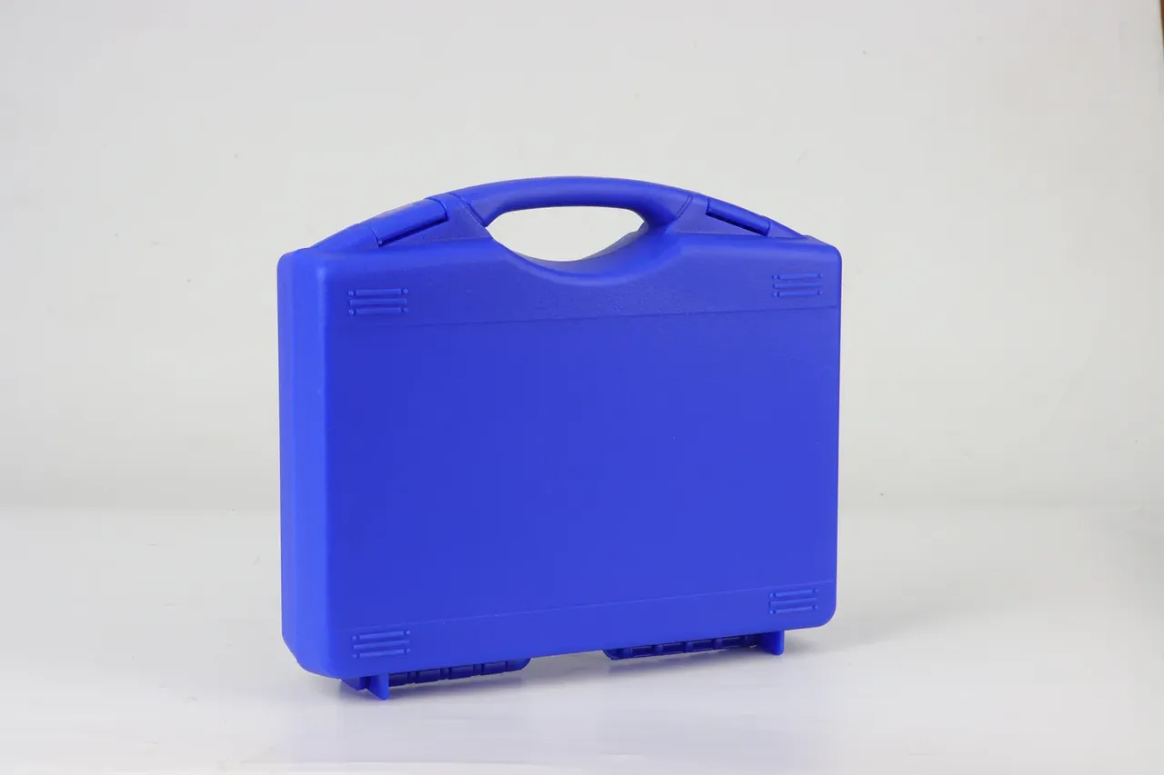 Light blue case closed, front view, molded center handle, corner ribs, latches and hinge along the base