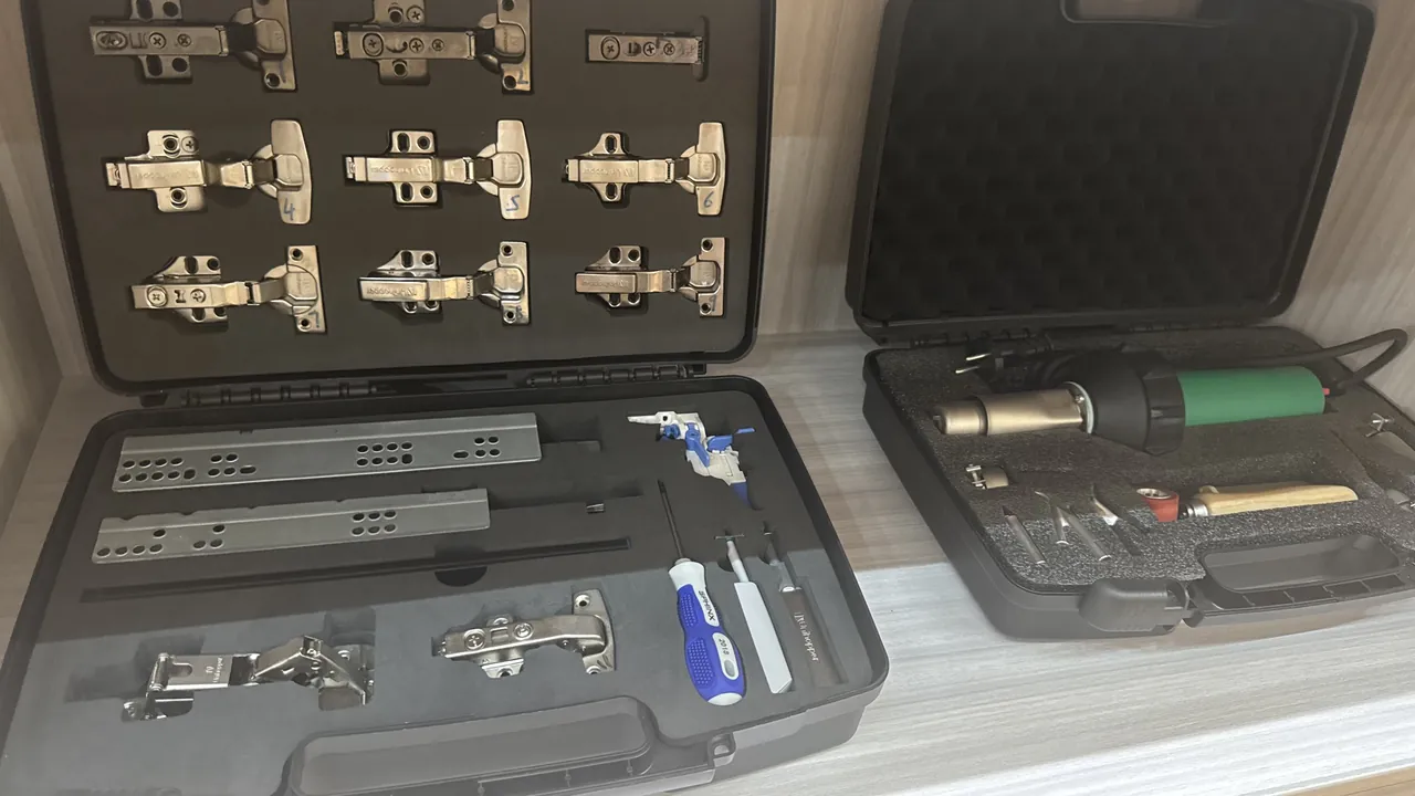 Training-ground scene of multiple sizes of tactical protective boxes with lids open, showing divided liners cut to equipment contours