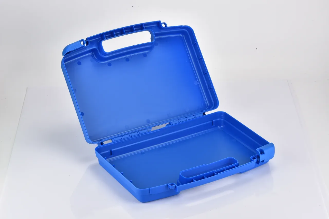Blue missile box open, radiused internal corners, vertical stiffening ribs inside the wall, hinge moulded into the lid edge