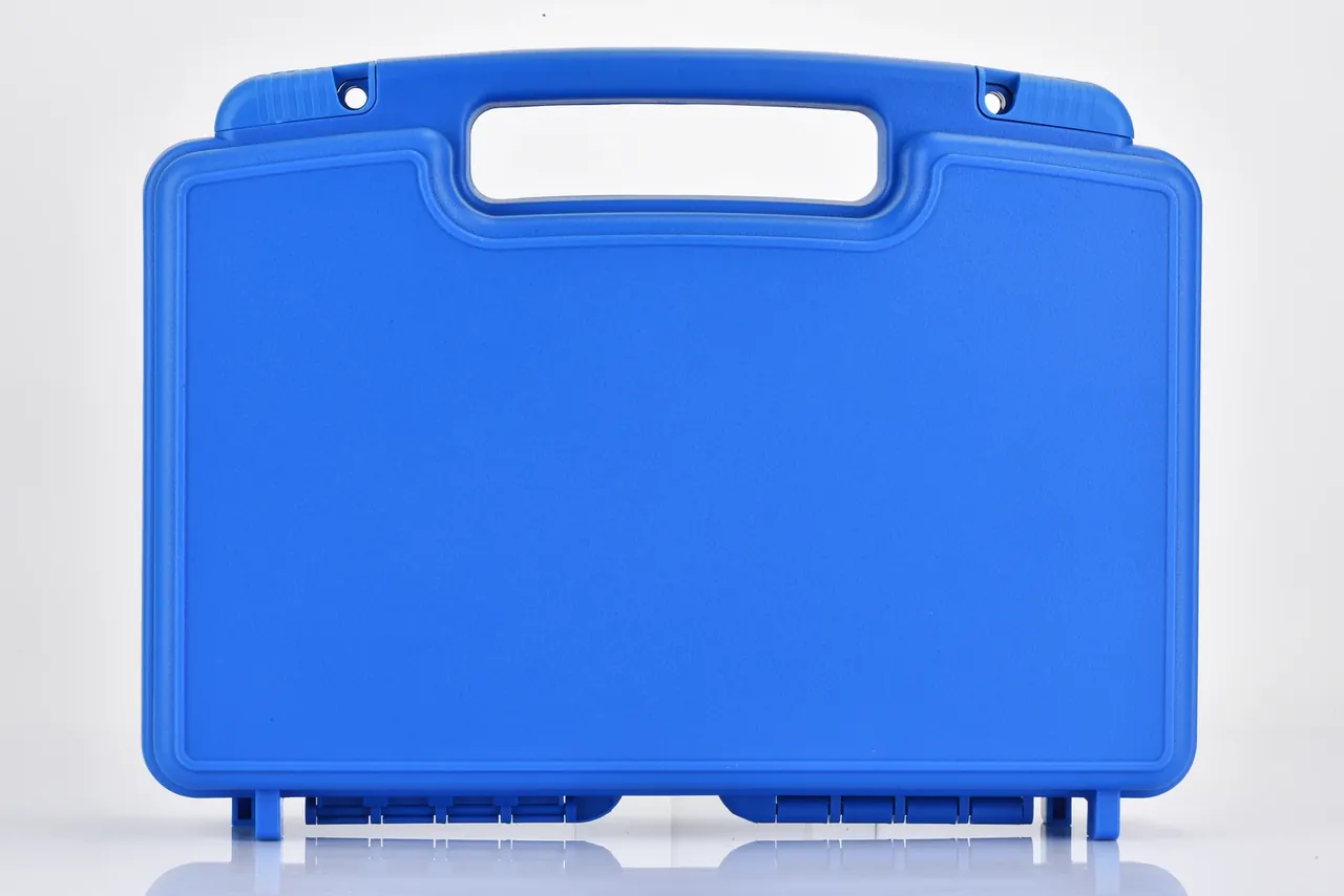 Blue missile box closed face-on, handle opening at the top edge, plain front without a recess, two feet at the base