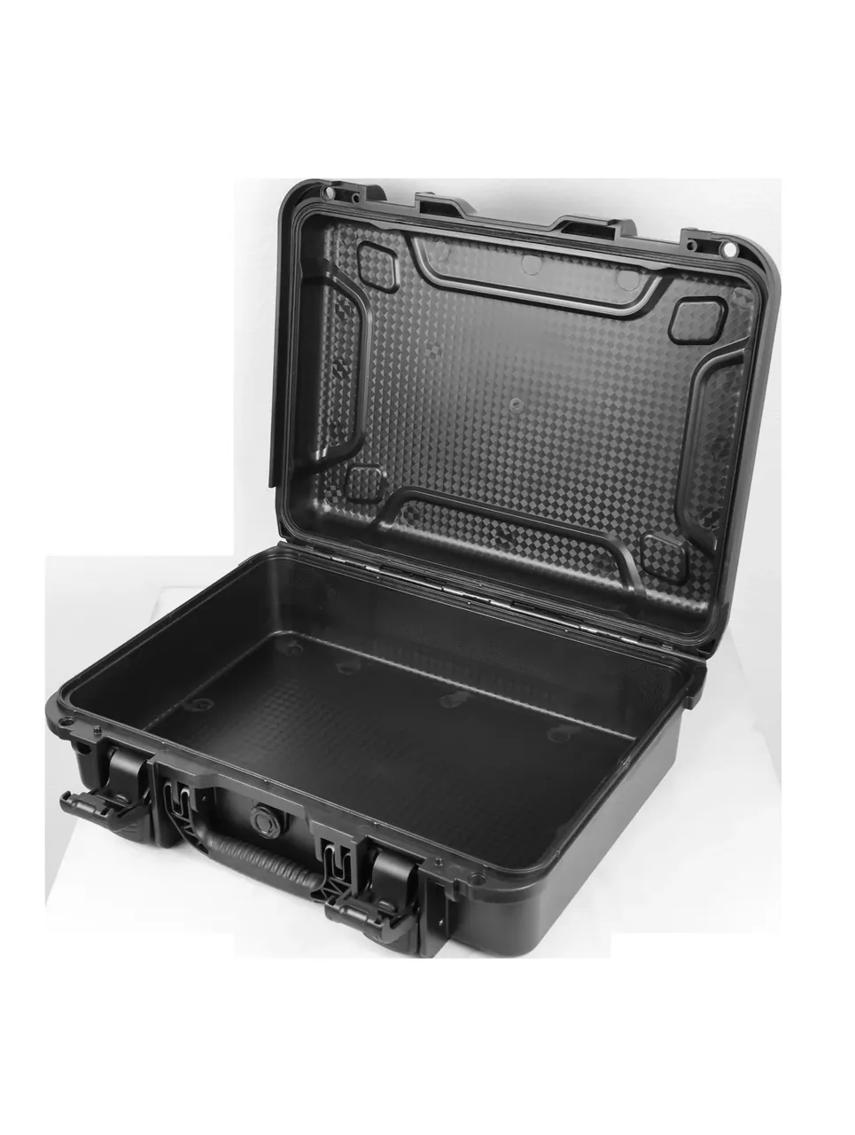 The case open: diamond texture on the lid interior, smooth cavity walls, a diamond floor with circular recesses