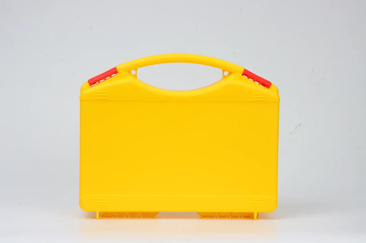 PP Plastic Case in lemon yellow standing closed against a white wall, red latches on both handle ends, two moulded ribs across the lid