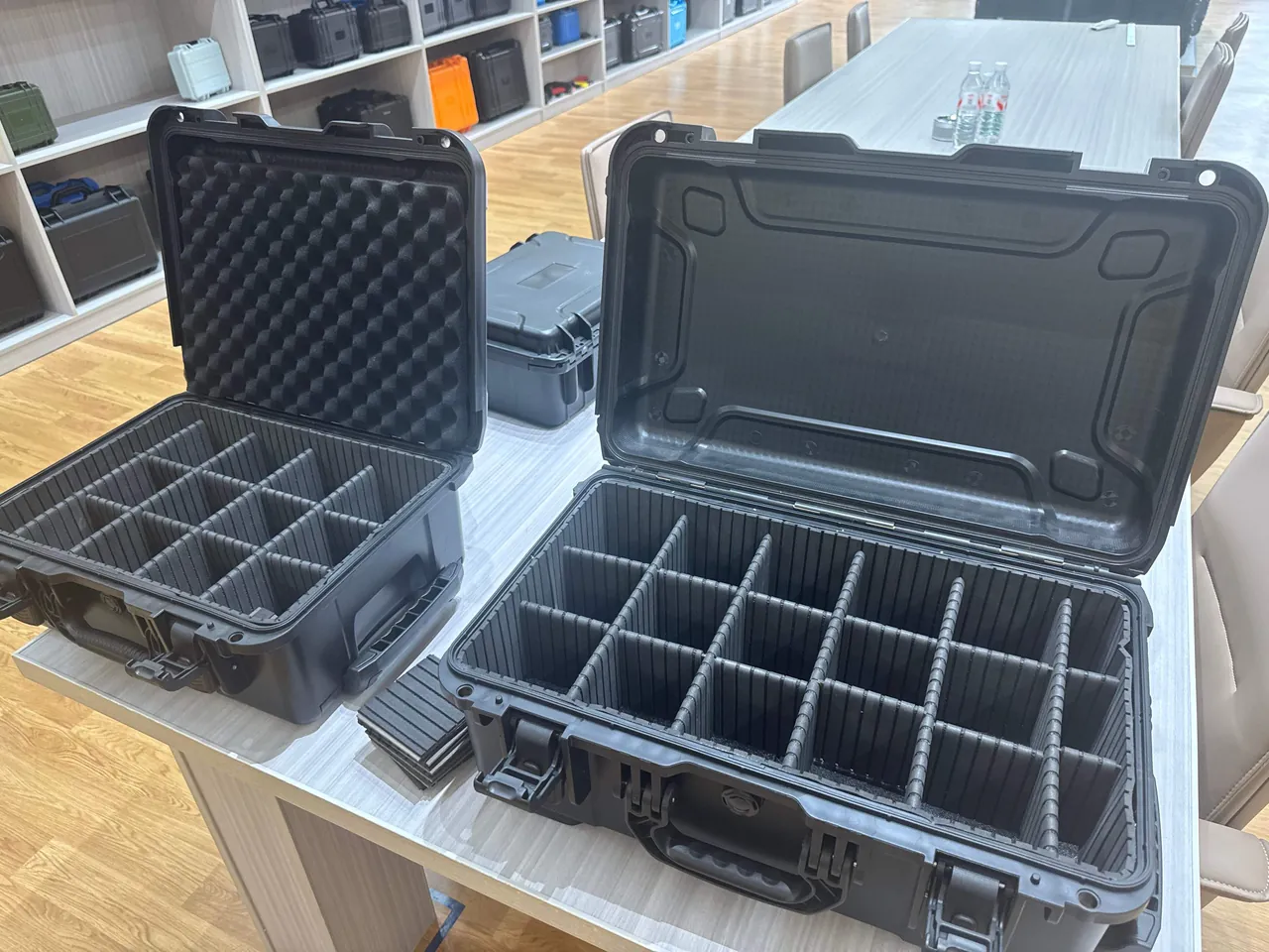 Jewelry trays arranged in partitioned sections inside a transport case with a soft contact layer