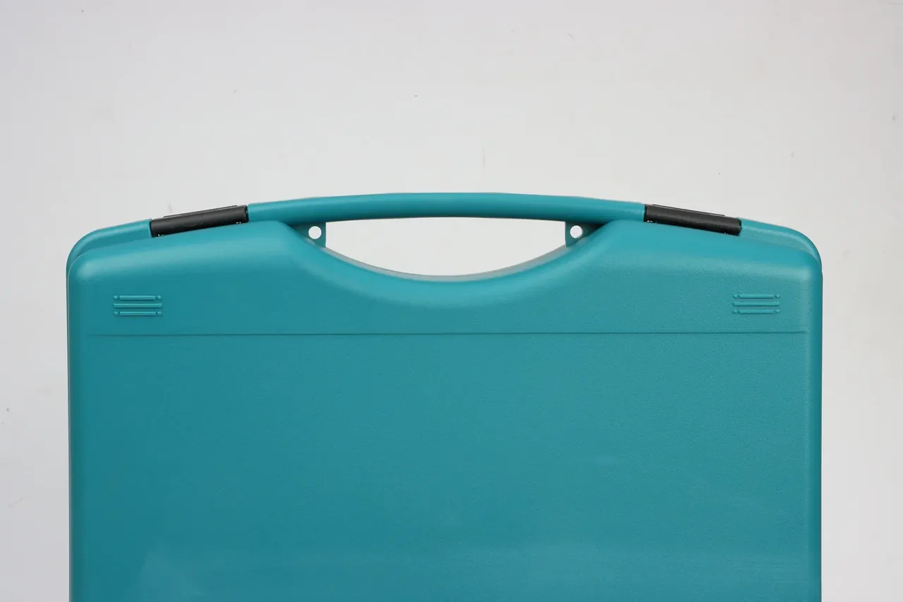 Teal case, upper half close-up, black sleeves at the handle sides, one round hole at each handle root, corner ribs