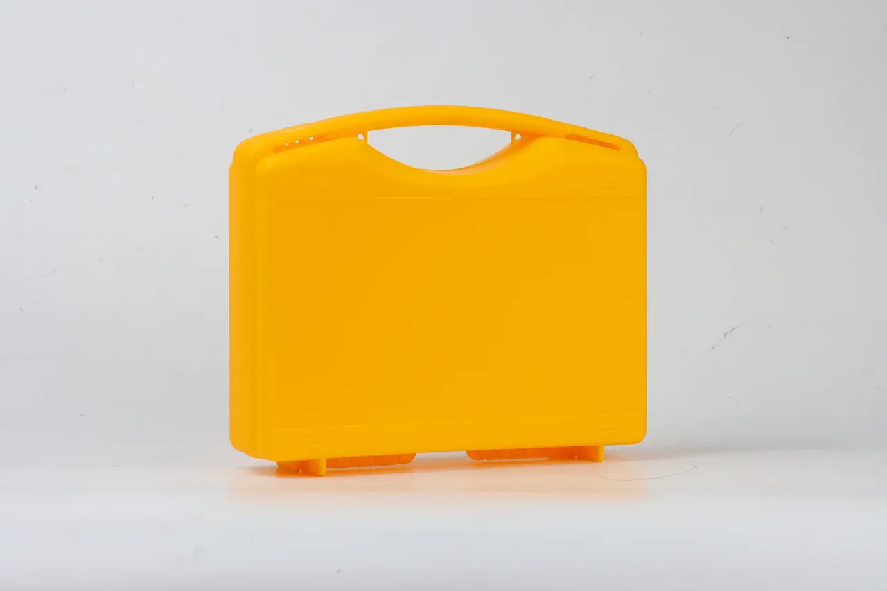 Protective Case Sales: amber yellow case facing front on a light grey background, lid shut, one-piece arched handle, four short embossed bars, two block feet