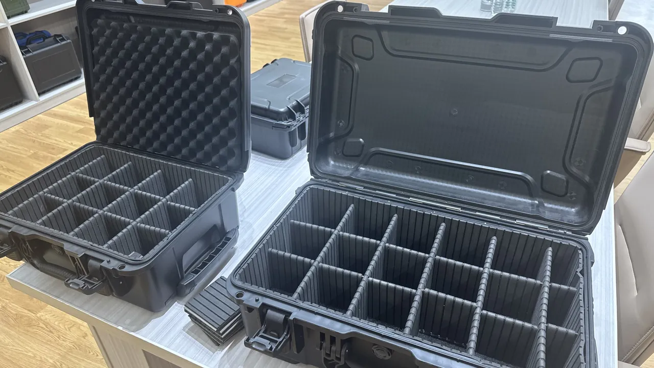 Close-up of a rugged plastic case with metal latches and EPDM sealing gasket, corner anti-vibration buffers visible on the box edges