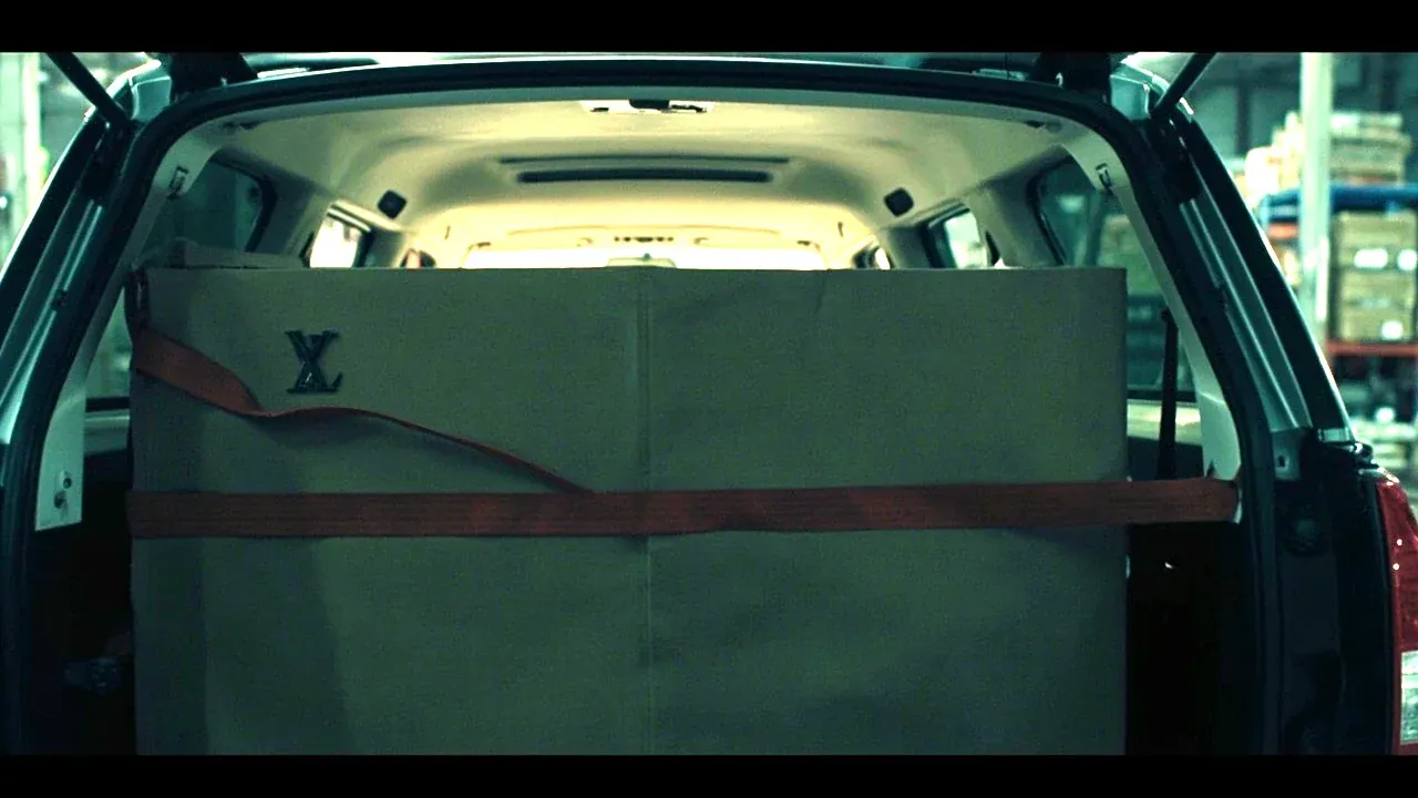 The case strapped in a vehicle with one strap over the middle