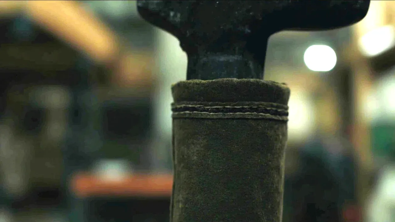 Close-up of a tool roll pocket edge with double stitching around a heavy wrench shank
