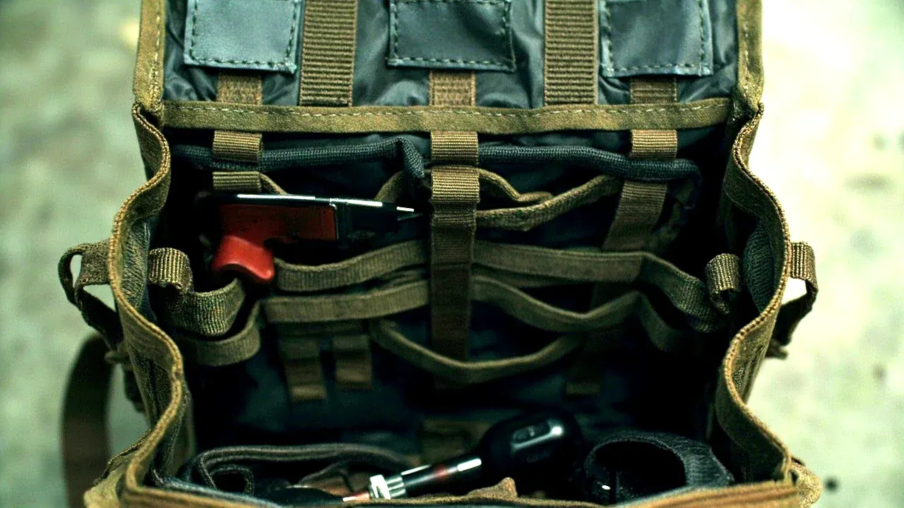 A tool satchel opened flat showing internal pockets and elastic tool loops, top-down view