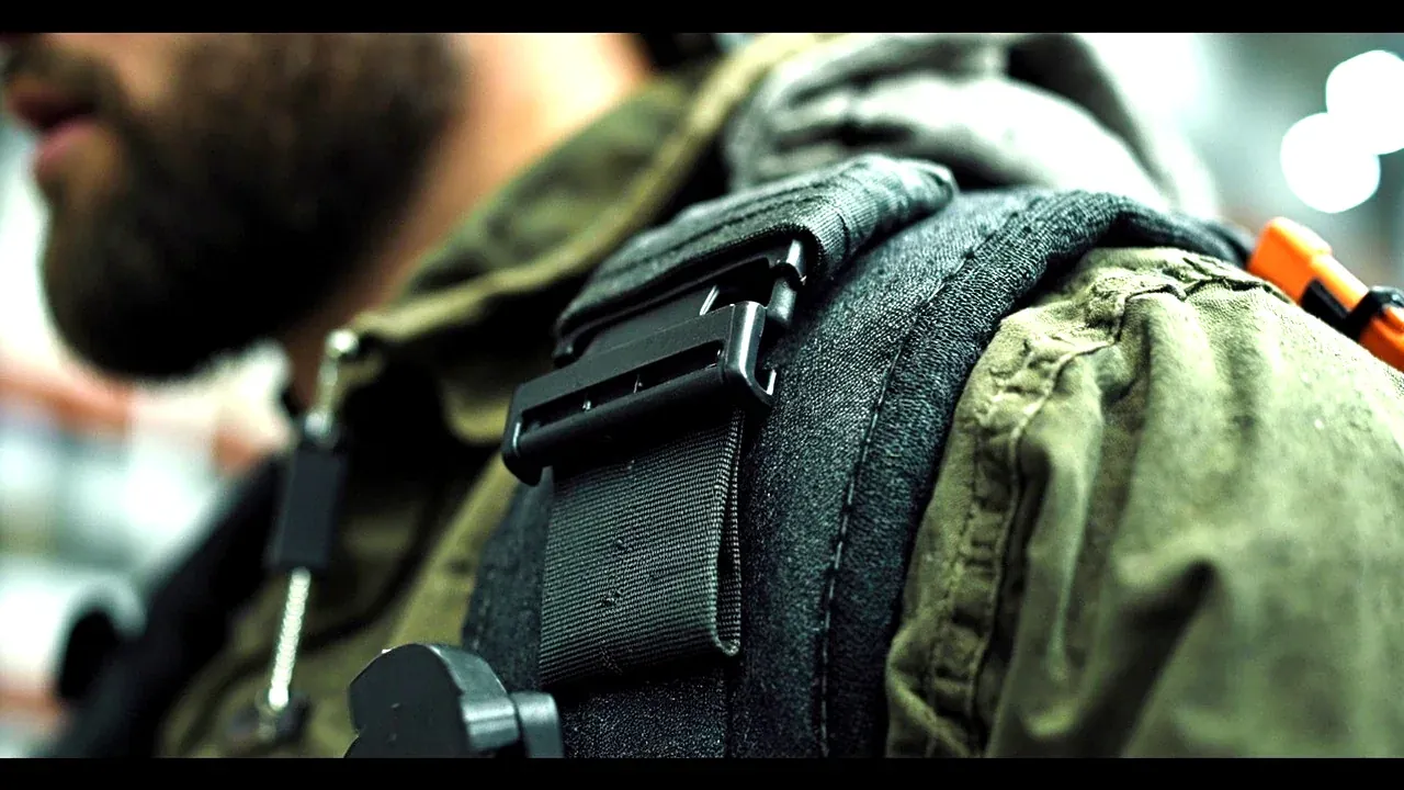 Close-up of a padded shoulder strap and its attachment point on a tool satchel